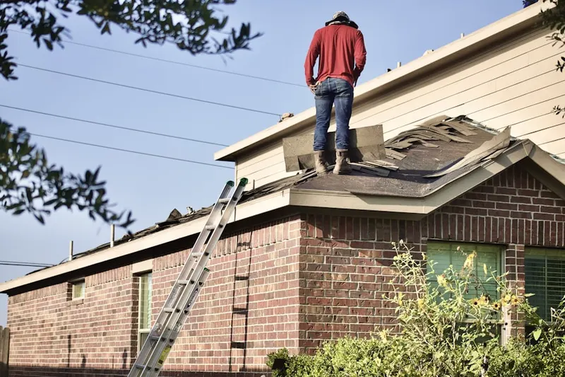 Professional roofer working on a residential roof in Wellington West